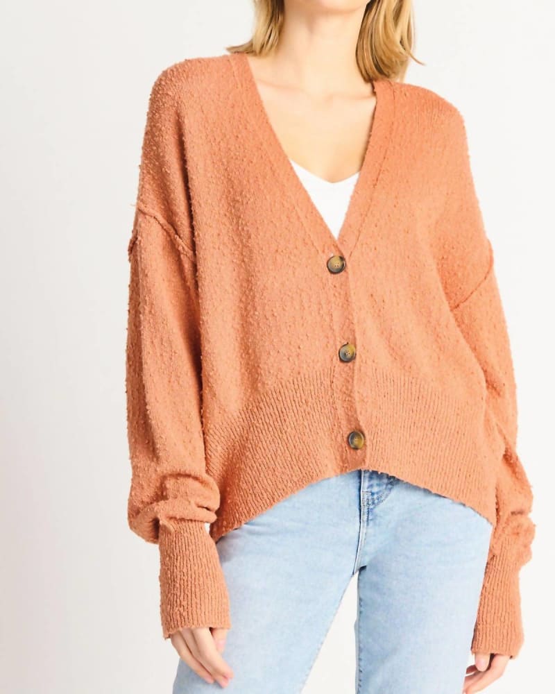 Front of a model wearing a size L Boucle Button Front Cardigan in Orange in Orange by Dex. | dia_product_style_image_id:325728